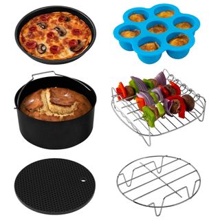 An air fryer accessory kit with a circular rack, square rack with uncooked veg skewers, blue silicone circular molds, a pizza, cake and black flat rack