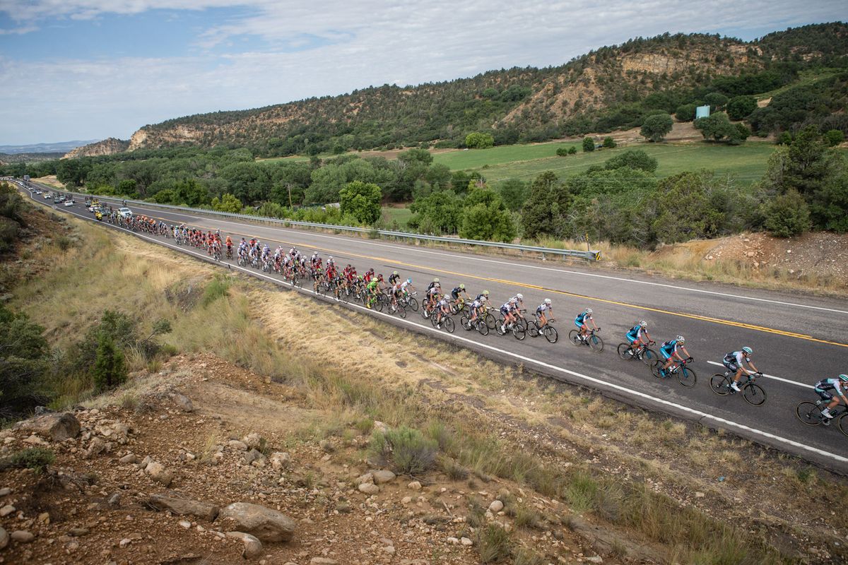 The peloton gets strung out as the break increases its leads