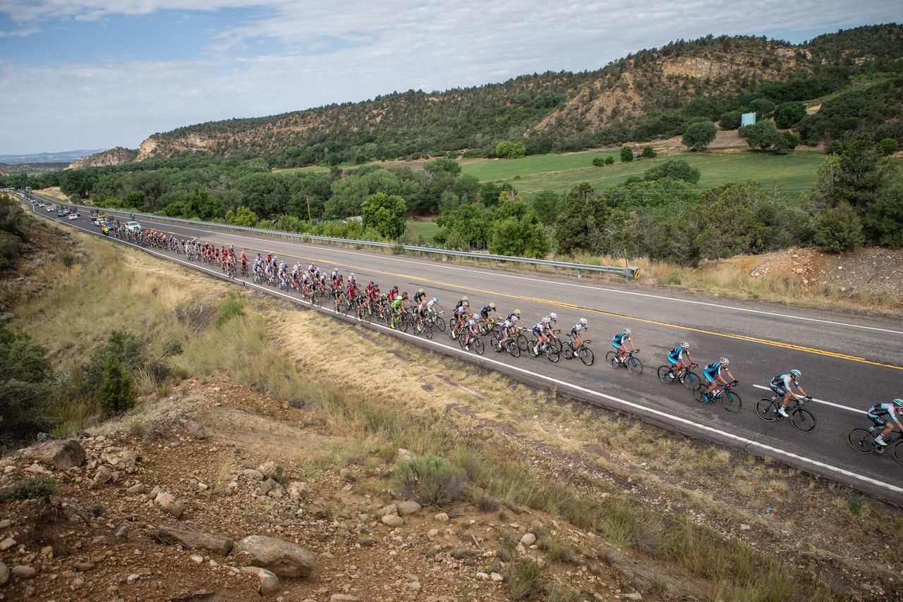The peloton gets strung out as the break increases its leads