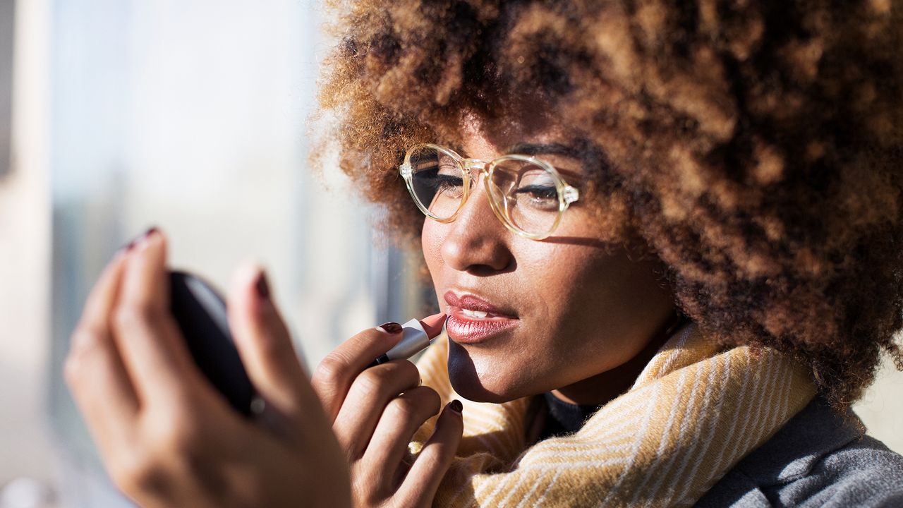 woman applying lipstick