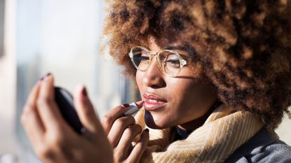 woman applying lipstick