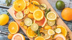 Bed of citrus, with oranges, lemons and limes cut in half - for article on 10 ways to clean with citrus peels
