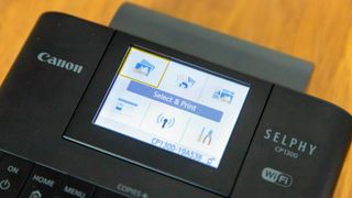 Canon SELPHY CP1300 Wireless Compact Photo Printer being tested in writer's home