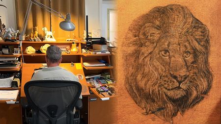 Aaron Blaise working at this Disney desk where he worked on The Lion King and a detail showing an image of a lion etched into wood