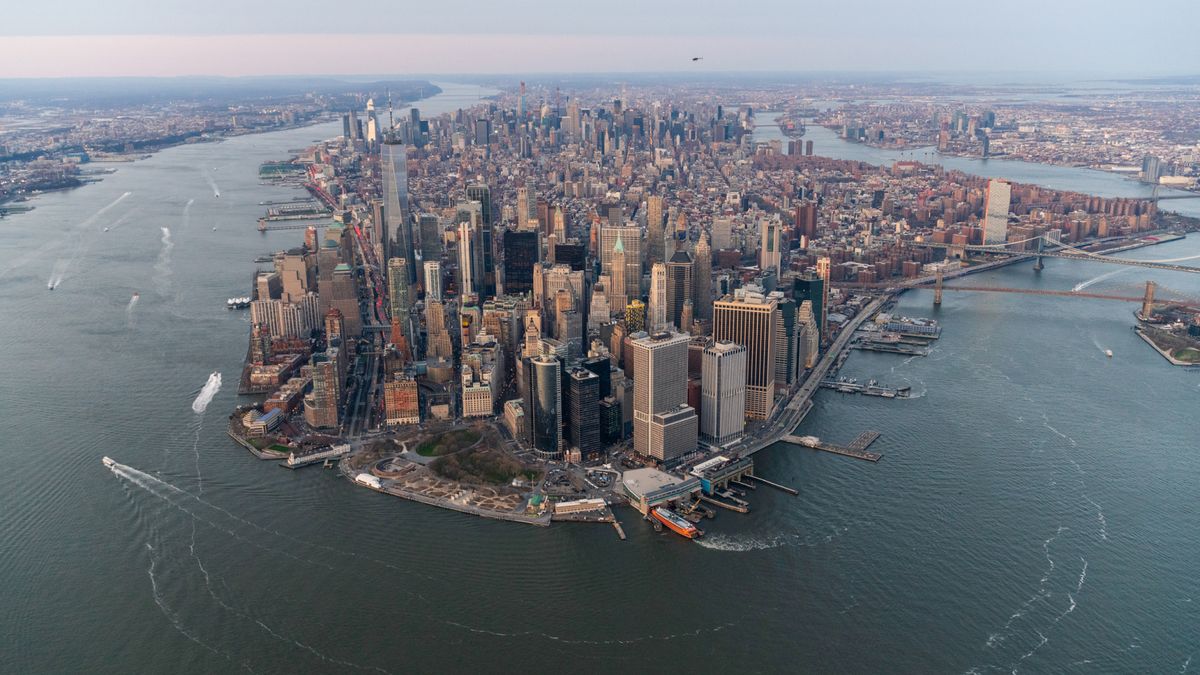 Aerial shot of the cityscape of New York City, surrounded by the ocean.