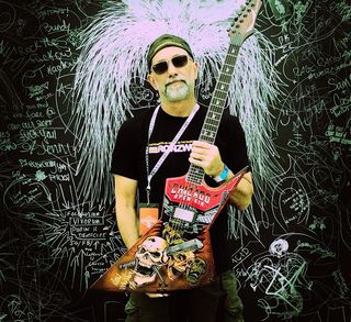 Ron Williams with his personally painted Chicago Open Air exclusive guitar signed by Dave Mustaine of Megadeth.