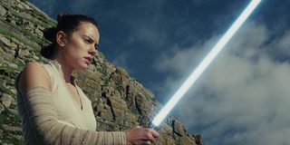 Rey wielding lightsaber in Star Wars: The Last Jedi