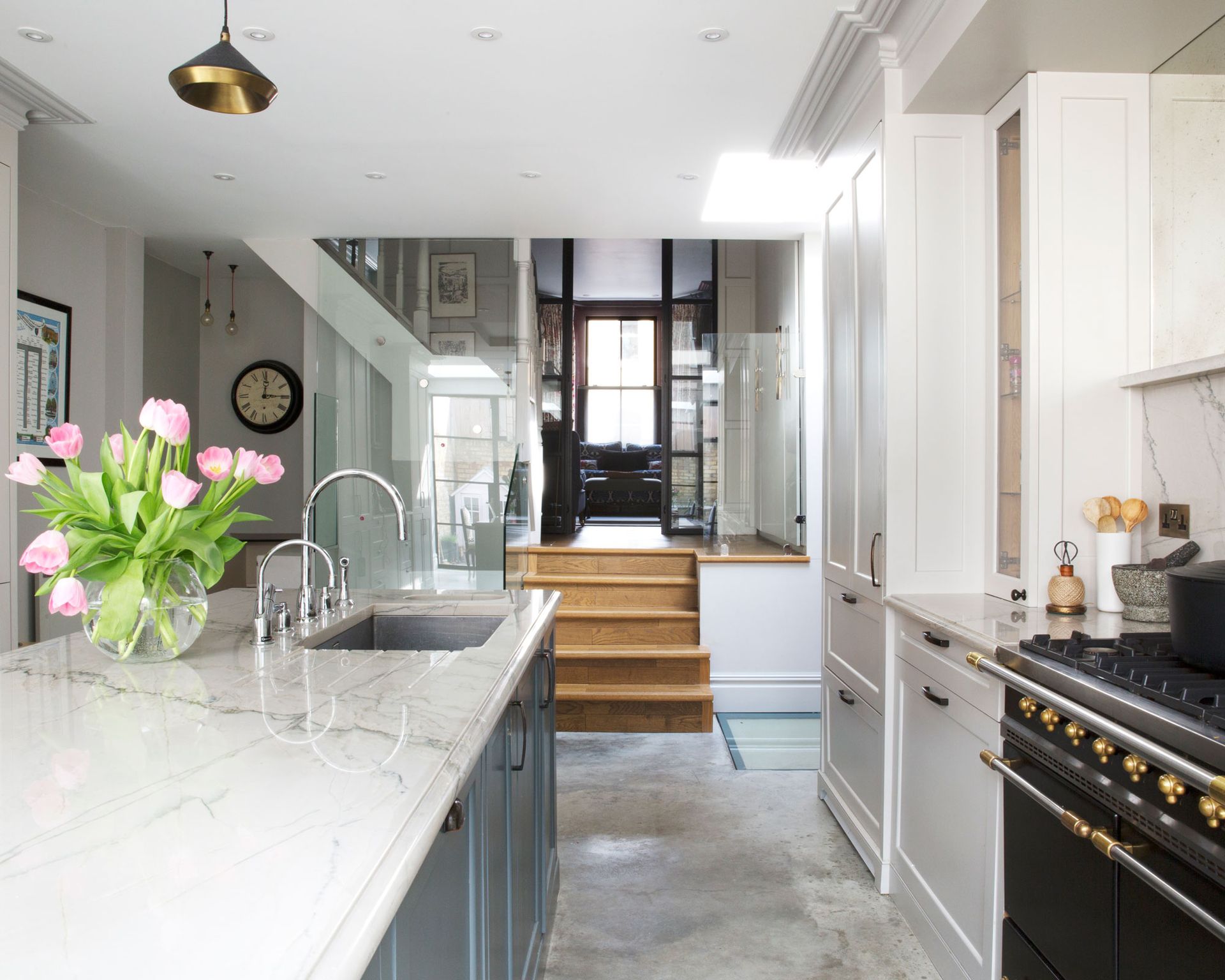 kitchen with island, large black oven and beige cabinetry