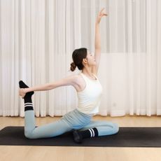 Model practicing mid-workout wearing some of the best Pilates socks