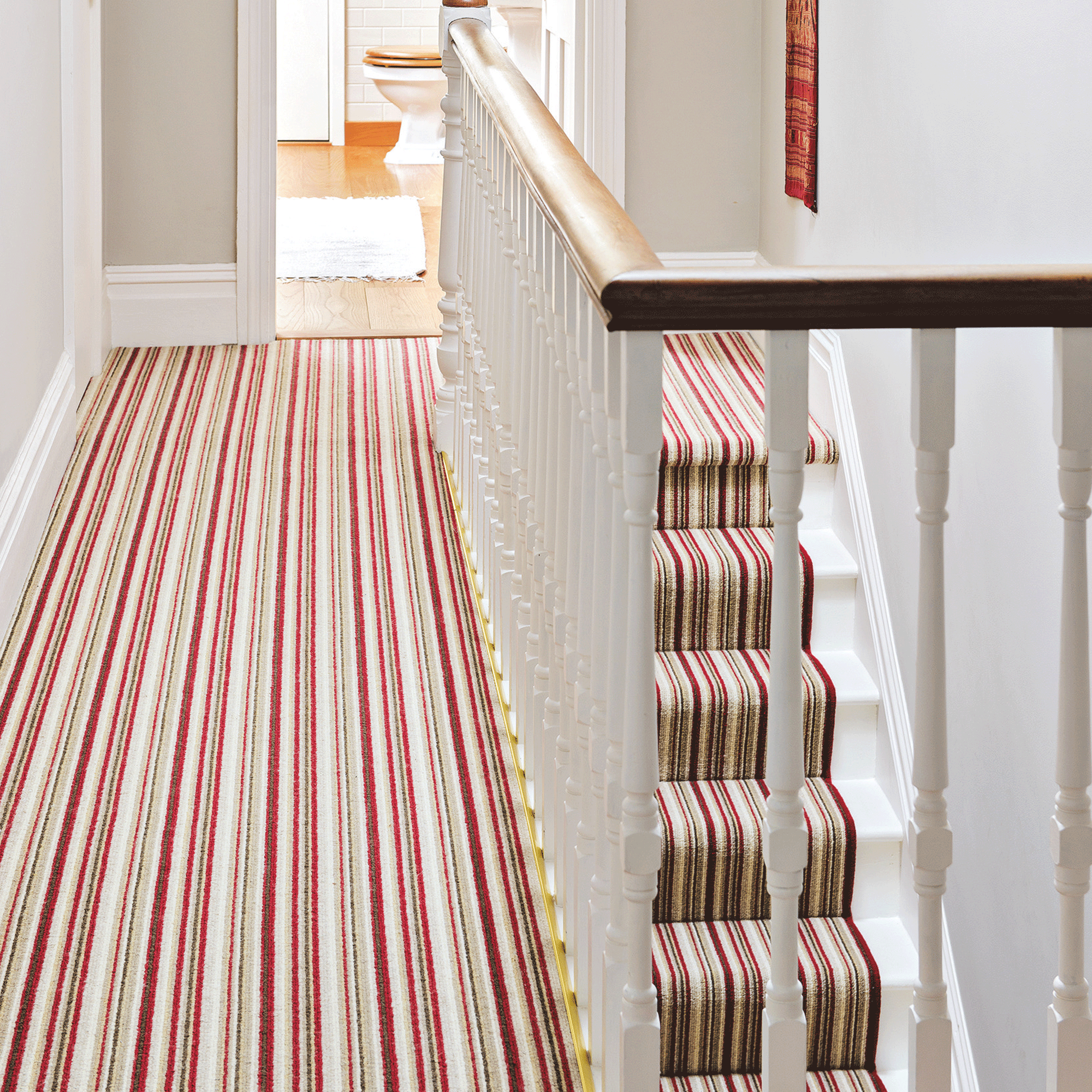 Striped carpet down red stairs