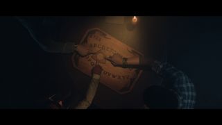 The gang playing with a Ouija board