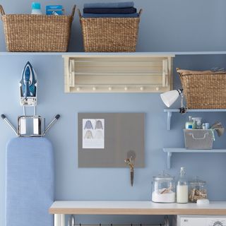 utility room with blue wall iron and ironing board