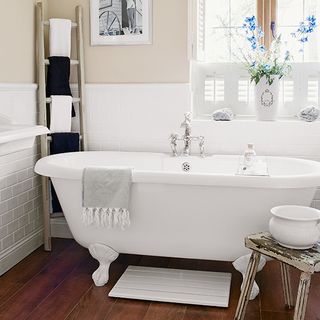 bathroom with towel ladder and wooden flooring