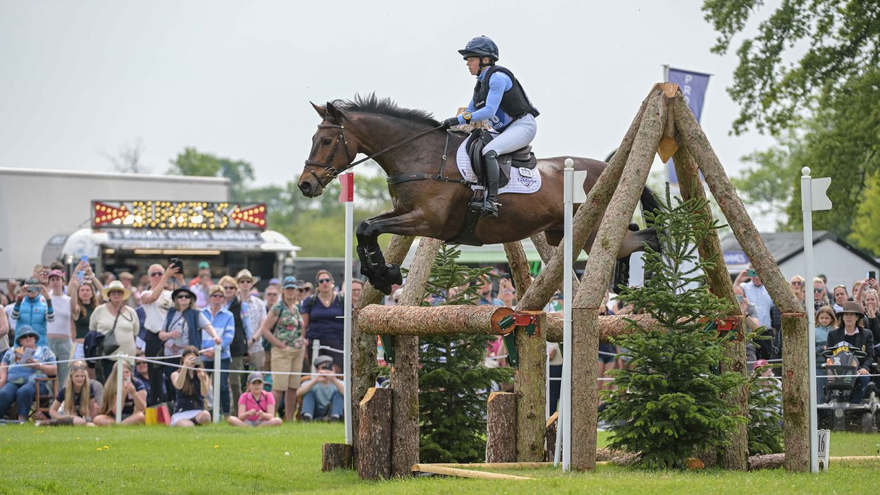Ros Canter and Lordships Graffalo clear a large rustic oxer with ease in front of the crowds on the Badminton Horse Trials cross-country course