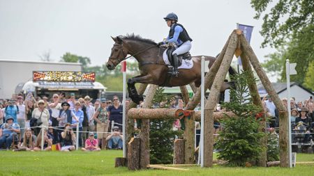 Ros Canter and Lordships Graffalo clear a large rustic oxer with ease in front of the crowds on the Badminton Horse Trials cross-country course