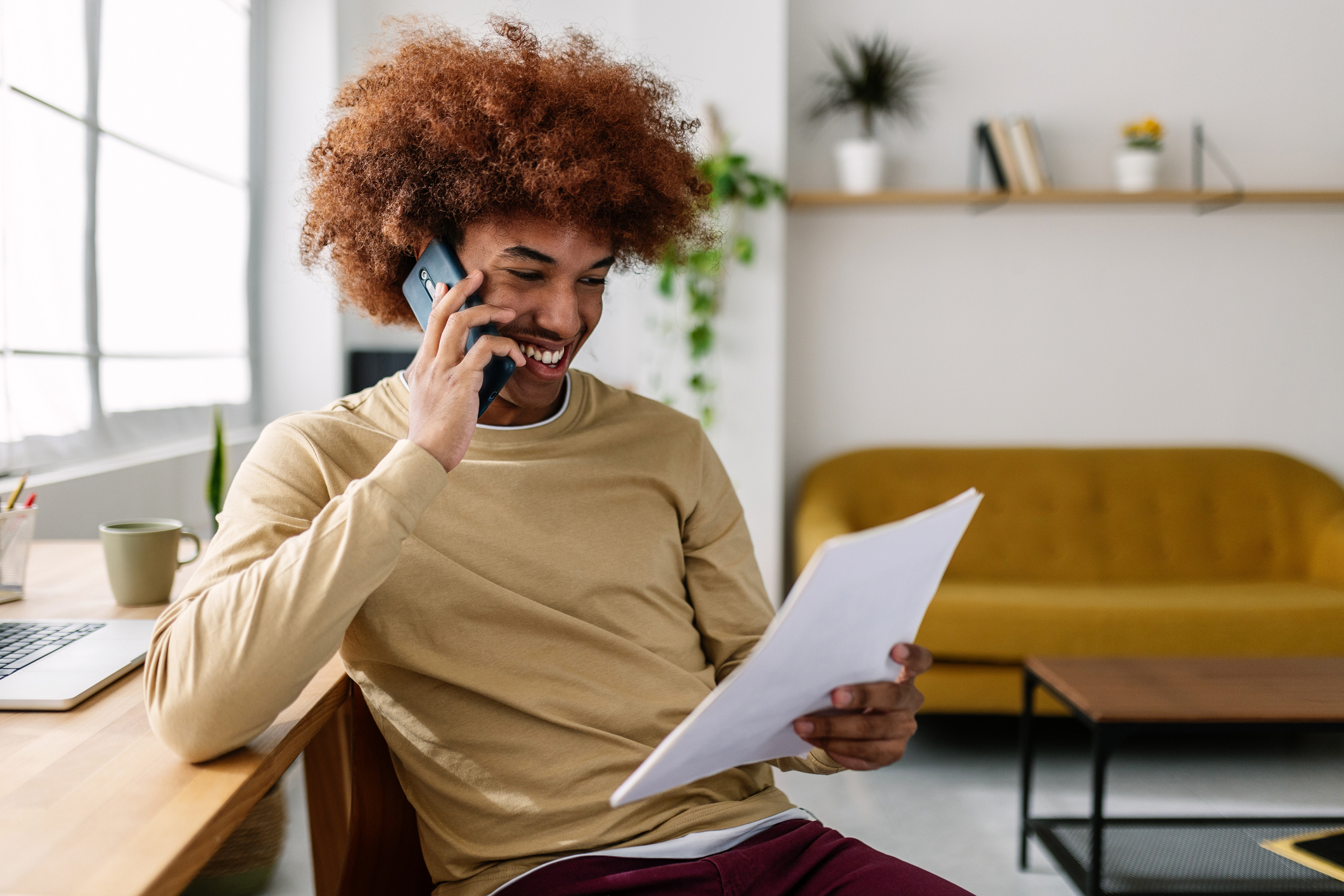 man looking at papers on the phone