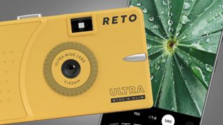 A Reto Ultra Wide and Slim compact camera next to an iPhone