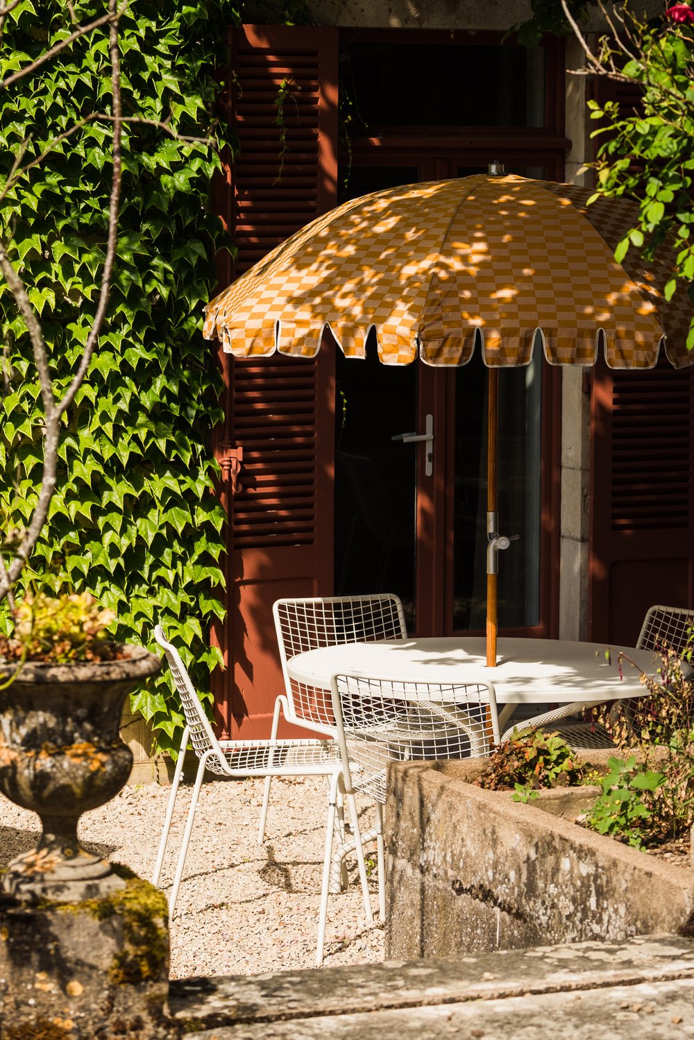 A whimsically decorated guesthouse pairs imaginative, color-blocky interiors with soft lines and palettes with a leafy, nature-immersed exterior.