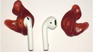 AirPods (1st gen) with red customized Avery eartips on white background