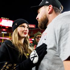 Taylor Swift and Travis Kelce on a football field
