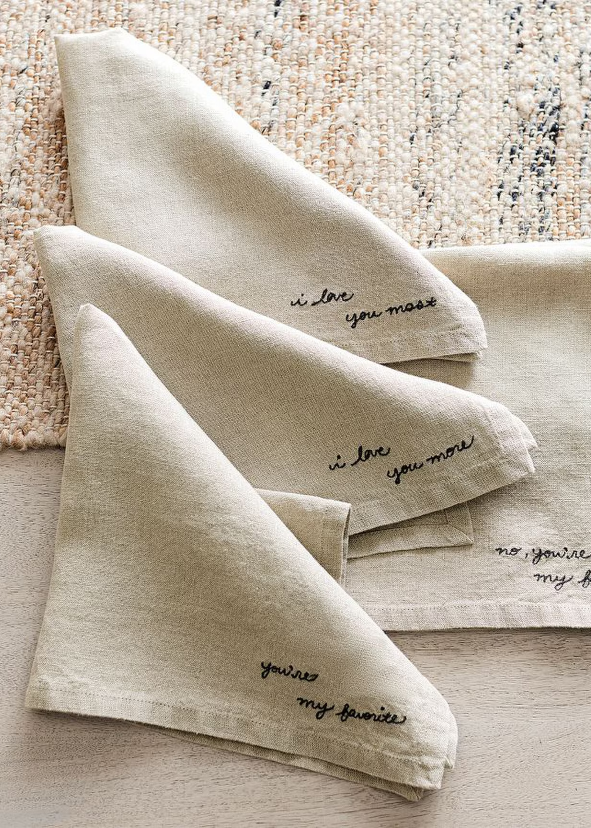 A set of embroidered napkins placed on a table