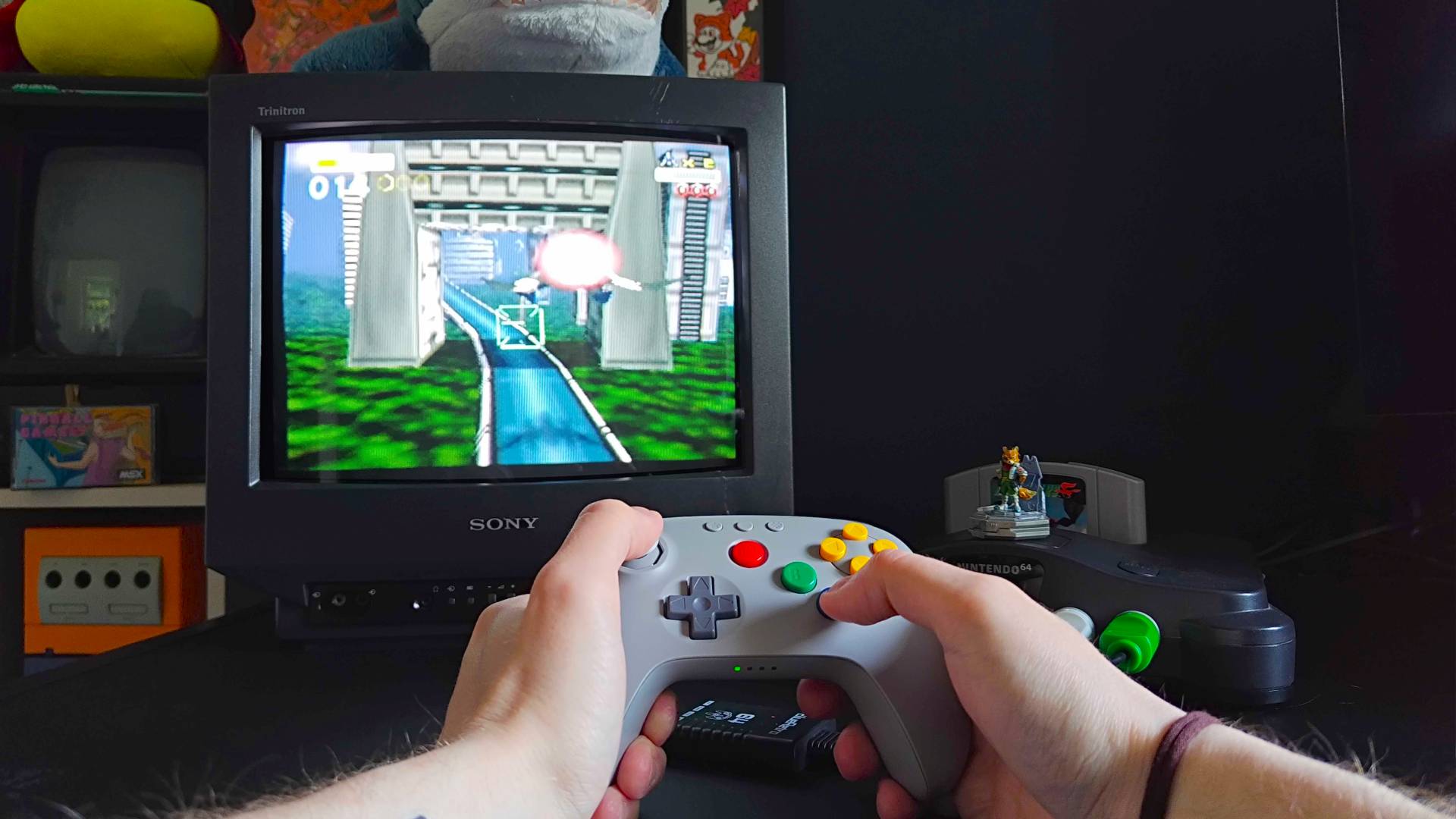 Phil Hayton holding 8Bitdo N64 controler while playing Star Fox 64 on N64 using Sony Trinitron CRT TV.
