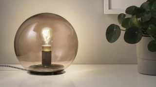 Ikea Tradfri filament light bulb in a clear round glass light fixture