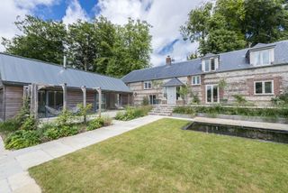 stone and brick converted barn with extension