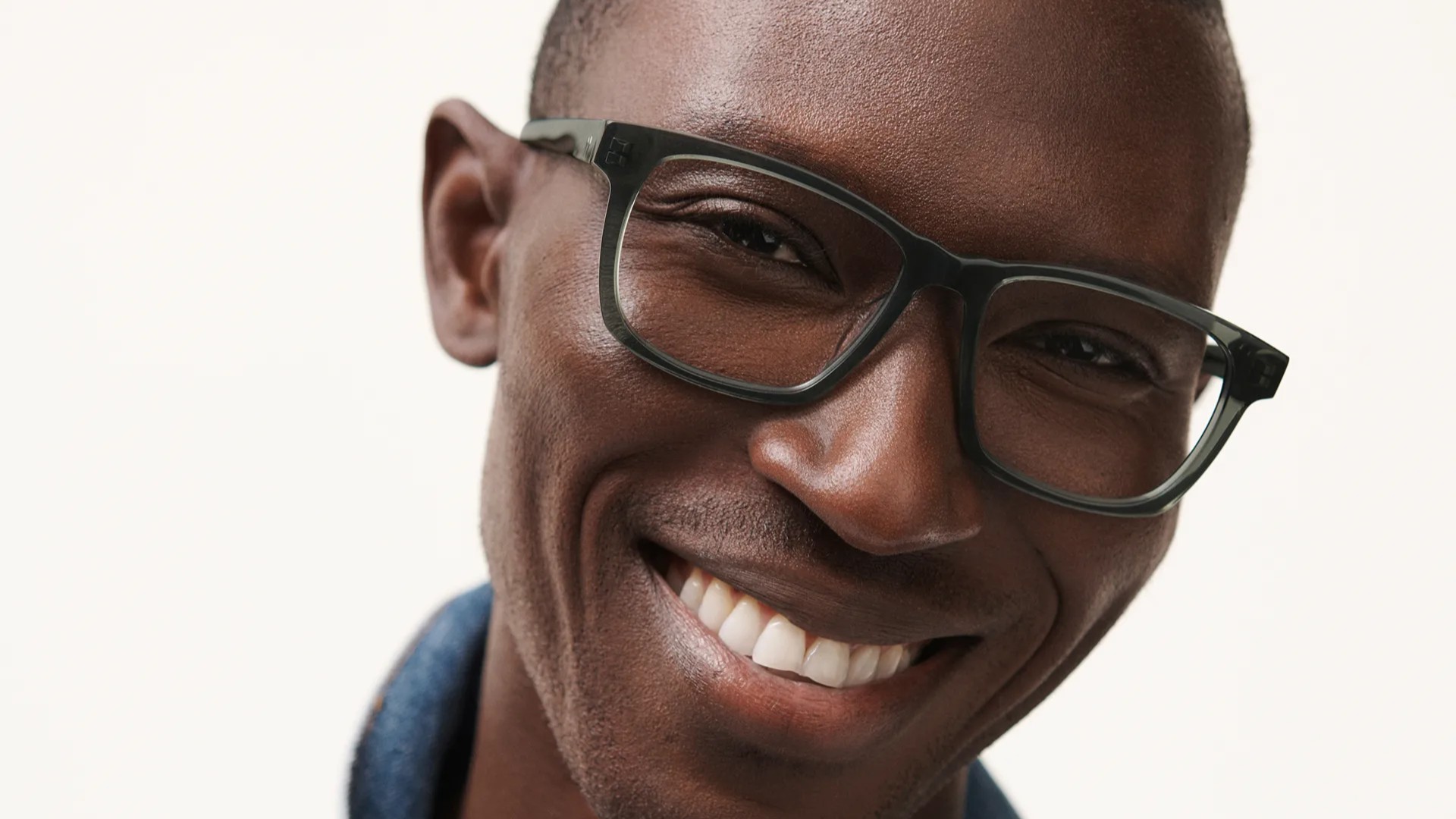 A man wearing Warby Parker glasses