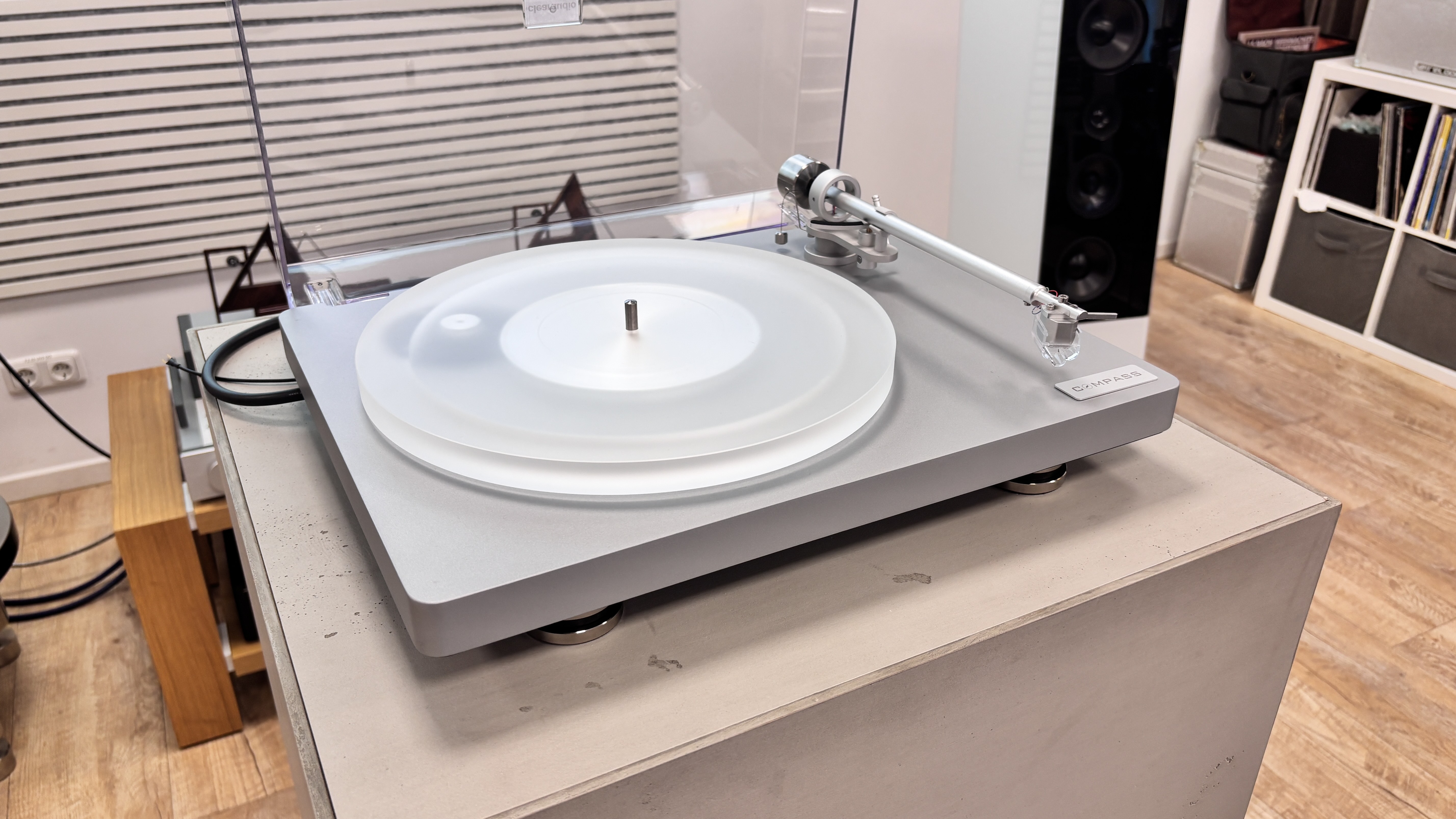 Clearaudio Compass turntable on a plinth in white