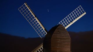Jupiter and Saturn converge above a windmill in Brill, England, during the "great conjunction" on Dec. 21, 2020.