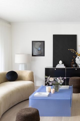 a living room with a light blue glass coffee table