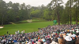 Augusta National 12th hole seen from the packed grandstand behind the tee