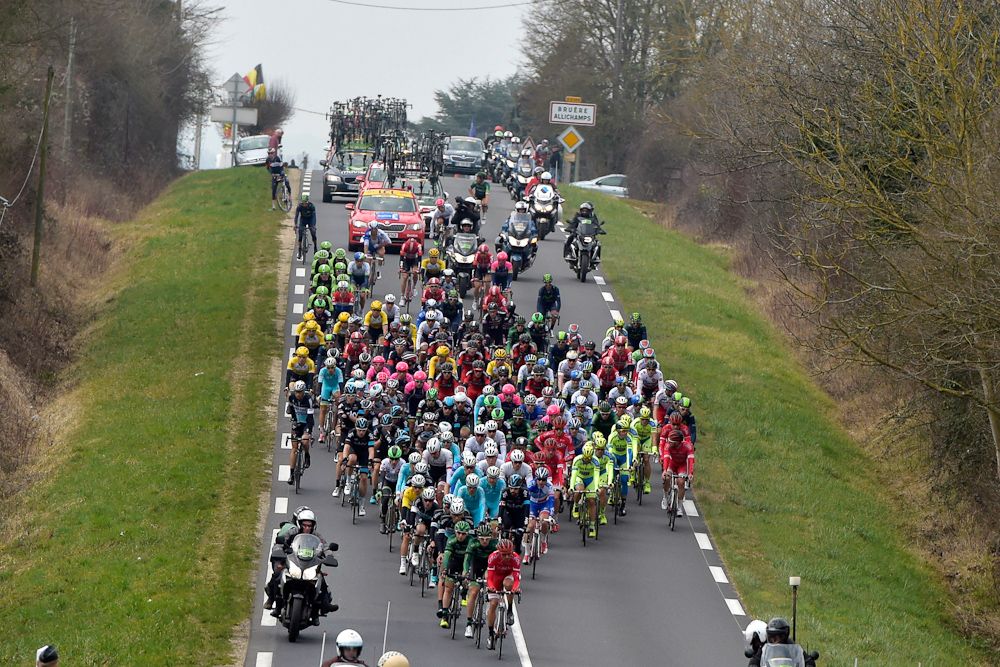 The peloton spreads out across the road.