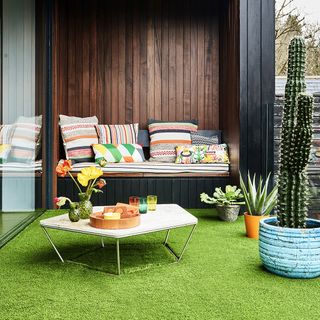 artifical grass with cushion and table