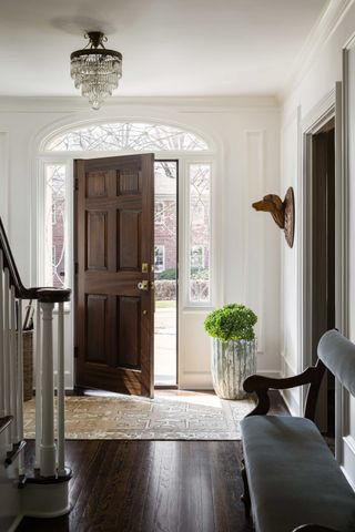 a light entryway with a brown front door