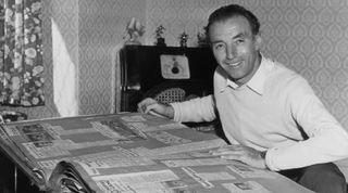Stanley Matthews looks through an album of the last 25 years before a dinner held in honour of his 25 years as a professional footballer at The National Sporting Club, 1956. (Photo by Daily Herald Archive/National Science & Media Museum/SSPL via Getty Images)