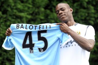 Mario Balotelli poses with the number 45 shirt after signing for Manchester City in August 2010.