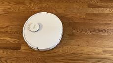 Yeedi M12 Ultra Plus robot vacuum on a wooden floor in reviewer's home