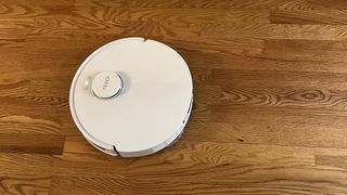 Yeedi M12 Ultra Plus robot vacuum on a wooden floor in reviewer's home