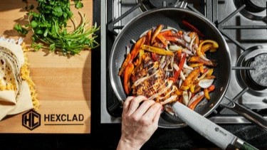 Someone cooking with a HexClad frying pan, knife &amp; chopping board