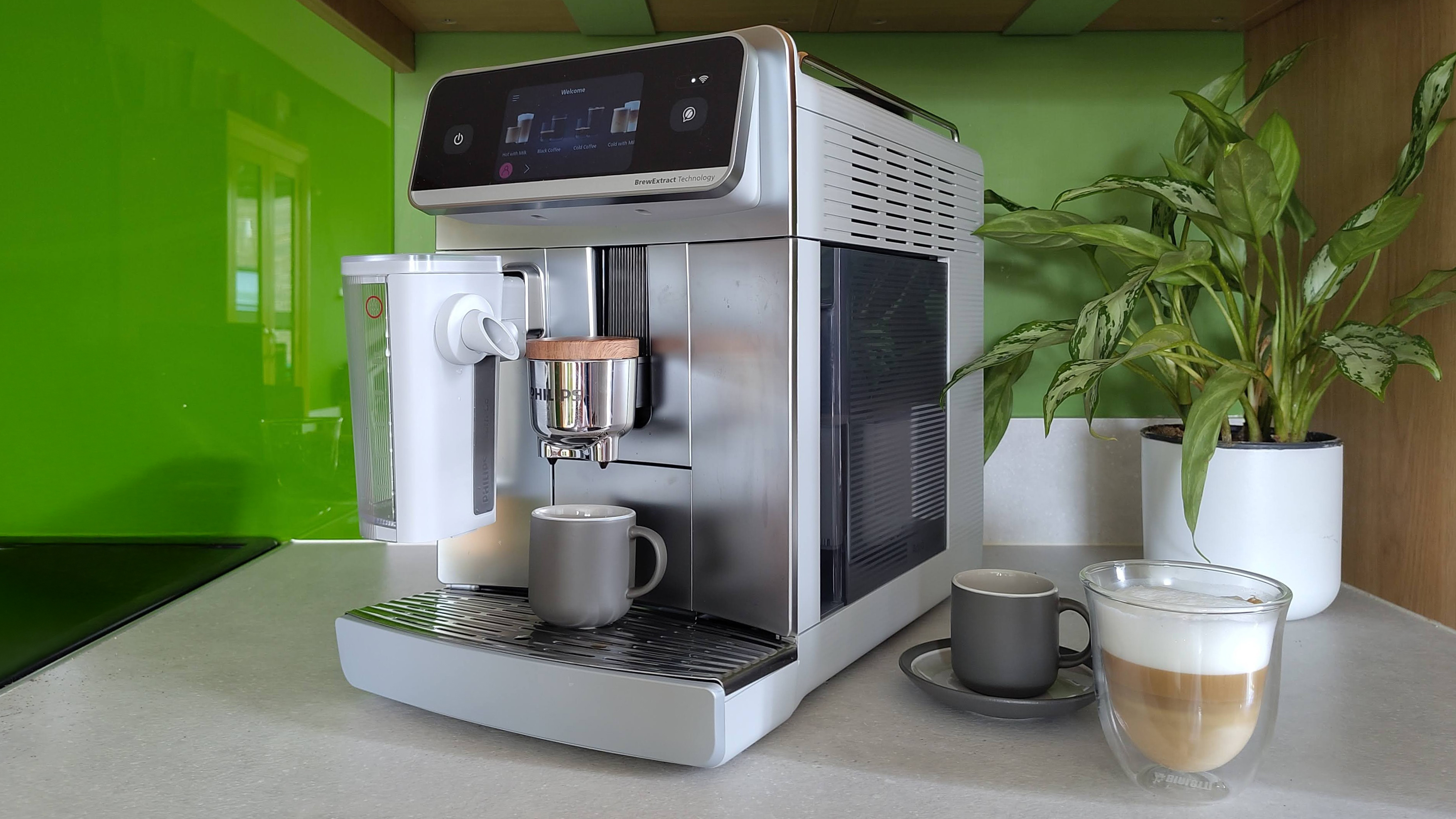 Philips Cafe Aromis Series 8000 coffee maker on kitchen counter with coffee and house plant
