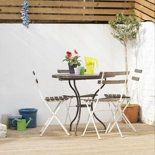 dinning table with chairs white wall and wooden flooring
