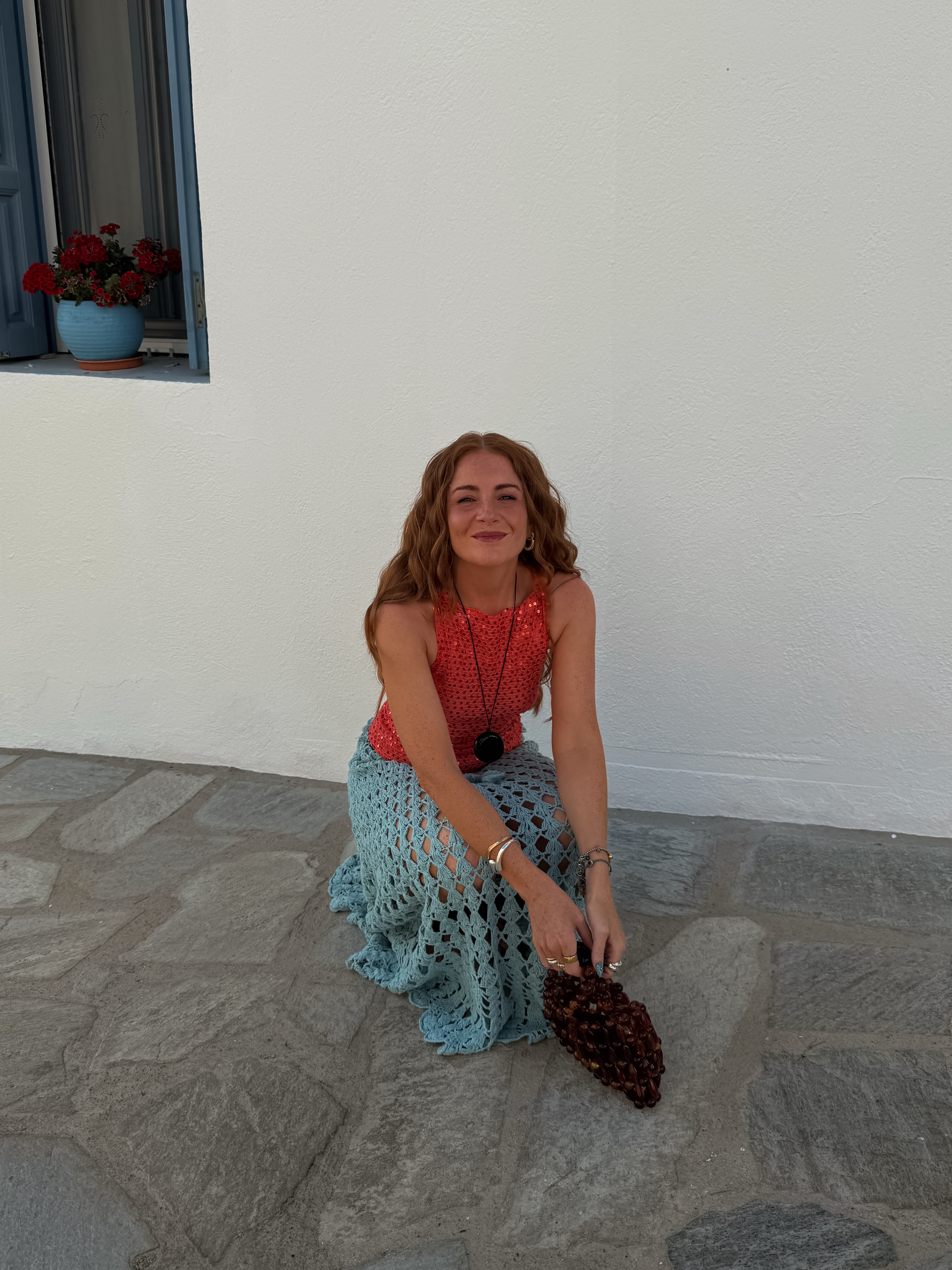 Rebecca in red top and aqua skirt
