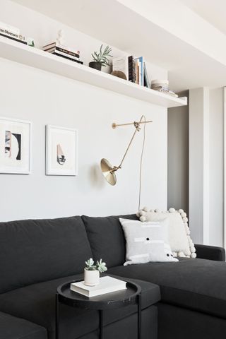 white living room with black corner sofa