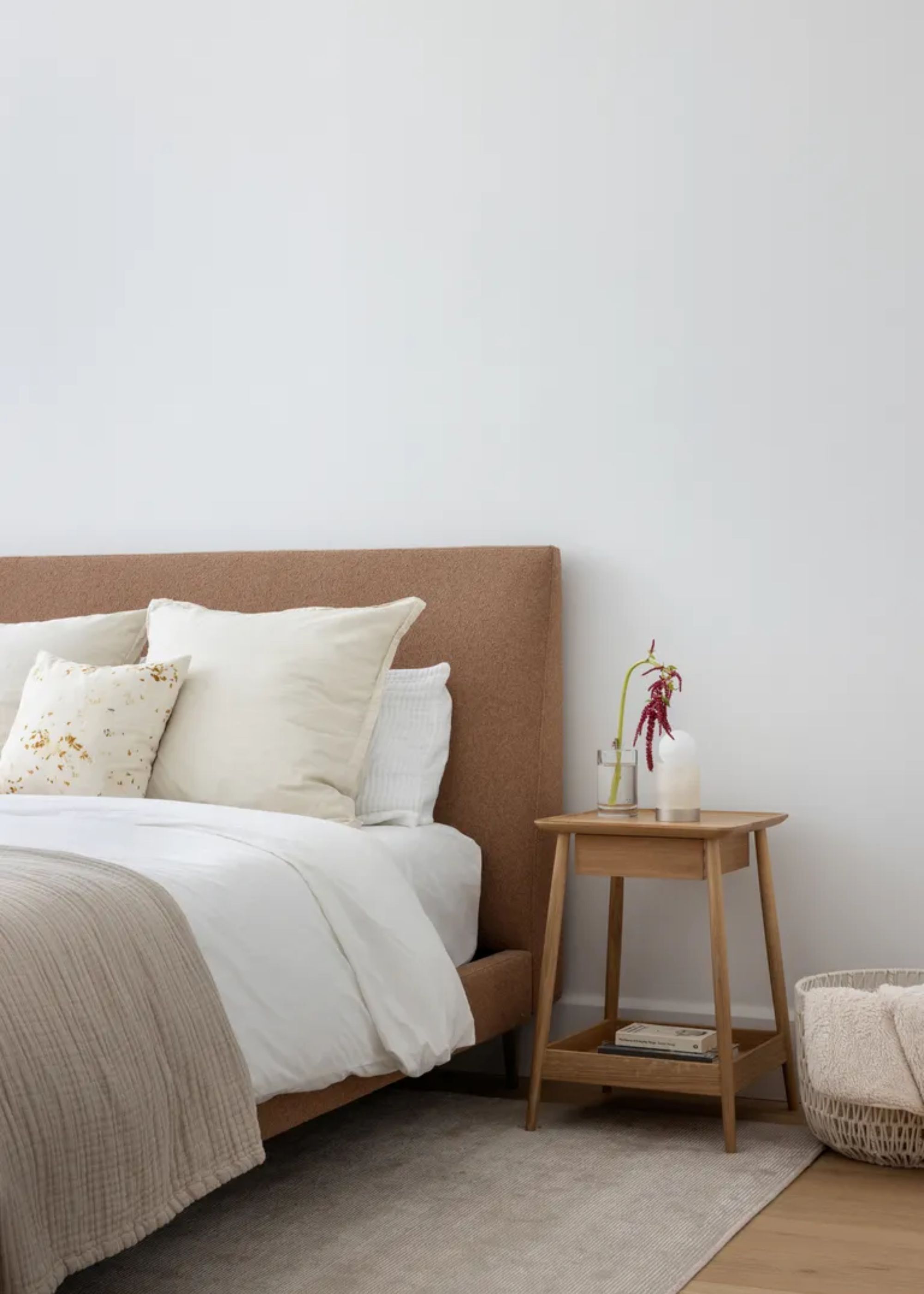 A minimal bedroom with a wooden side table