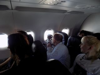 Eclipse chasers aboard a jet chartered by AirEvents/Deutsche Polarflug and Eclipse-Reisen prepare to observe the total solar eclipse of March 20, 2015 while flying over the North Atlantic Ocean.
