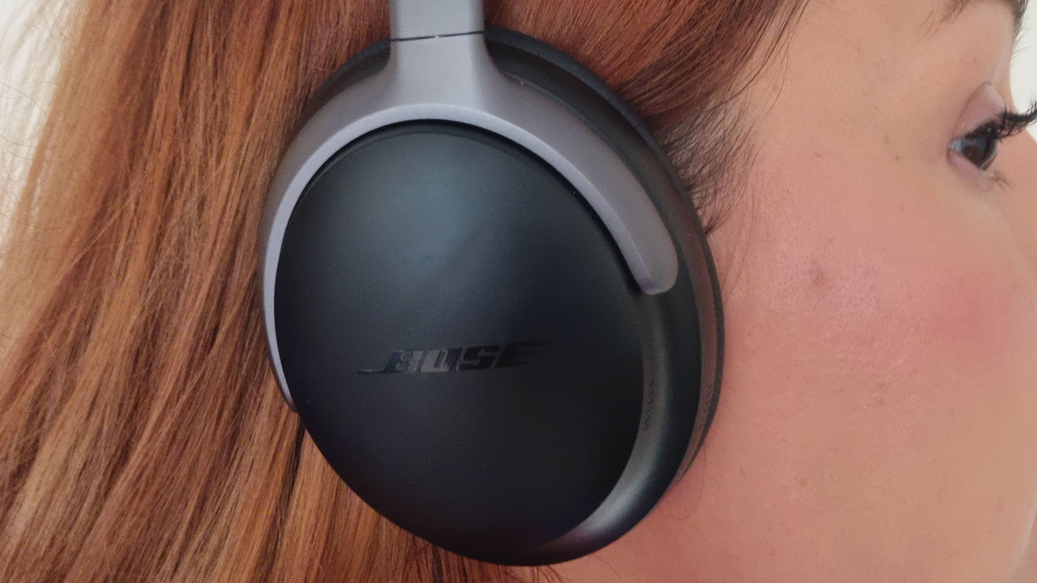 A close-up picture of our reviewer wearing the Bose QuietComfort headphones