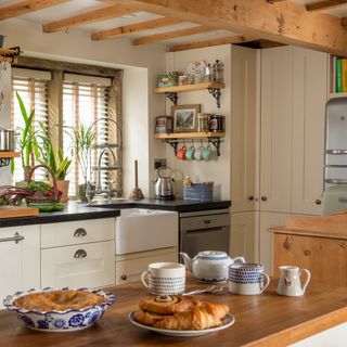 cottage kitchen with belfast sink and wall shelves