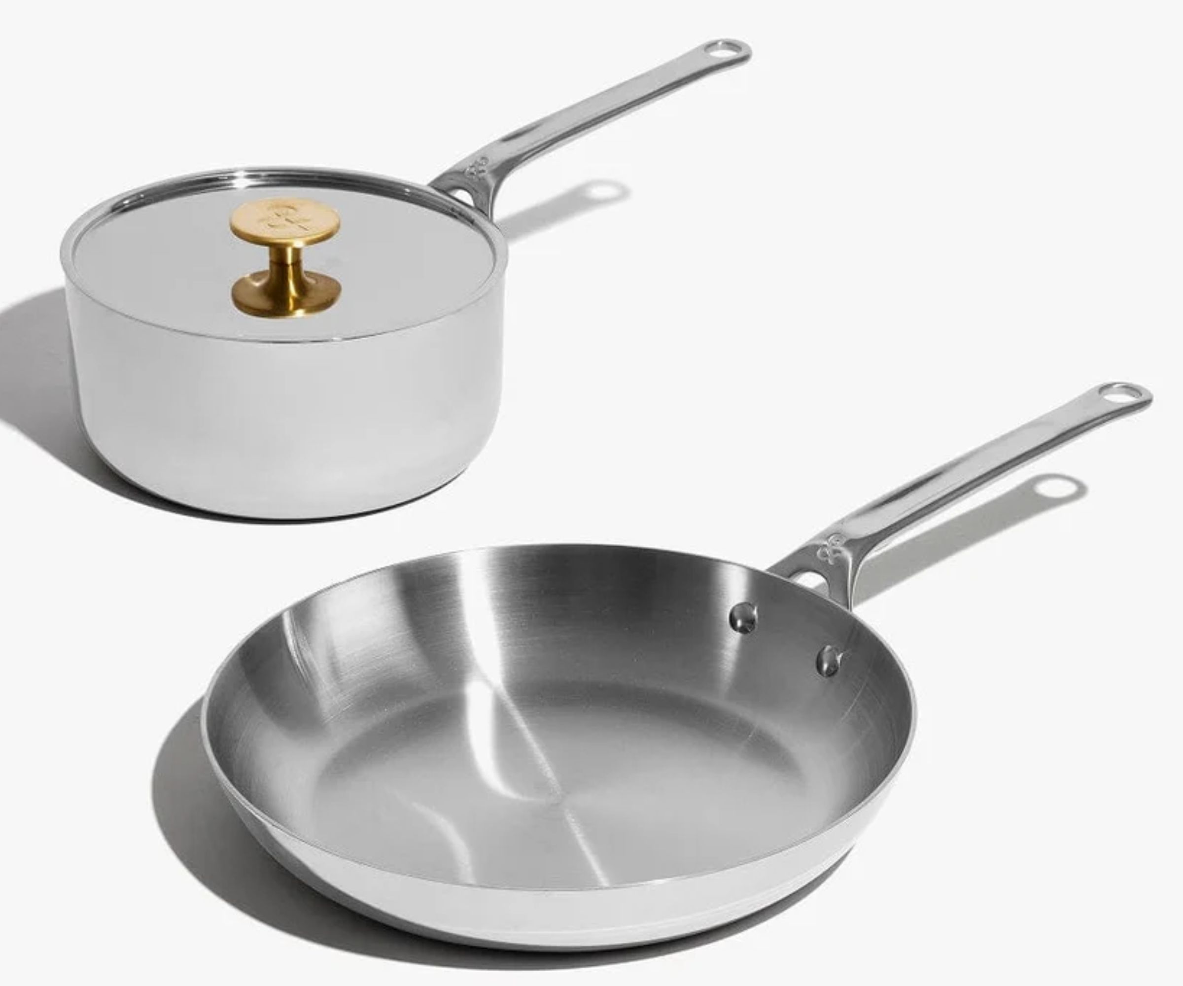 A set of two stainless steel pans, one sauce pan one frying pan